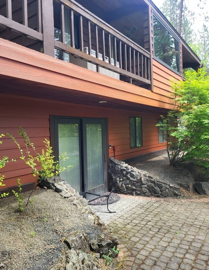 Cedar toned siding and dark brown deck balcony painting in Spokane